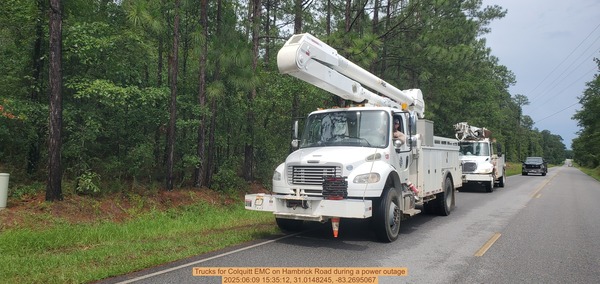 [Trucks for Colquitt EMC on Hambrick Road during a power outage, 2025:06:09 15:35:12, 31.0148245, -83.2695067]